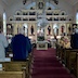 View of the iconostasis from the back of the church during the Paschal Midnight Office service. The church is lit only by candlelight, and is somewhat dark.