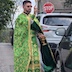 Photo of a closse-up of Fr. Aleksey blessing the aforementioned black vehicle. He stands on the left, and the car appears on the right side of the frame. His hand is raising in mid-blessing.